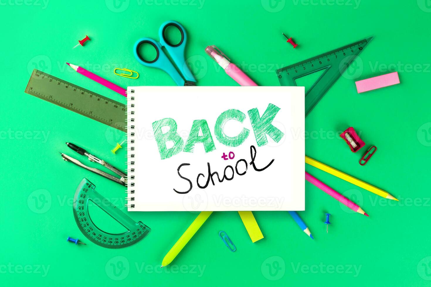 Flat lay composition with school supplies. composition with colorful stationery and white notebook andpencil inscription Back to school. Back top school concept. Top view photo