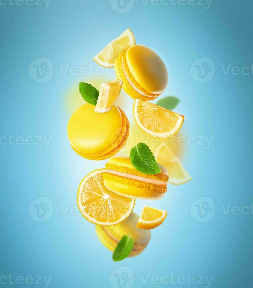 Levitating Yellow French Macarons with mint leaves with lemon photo