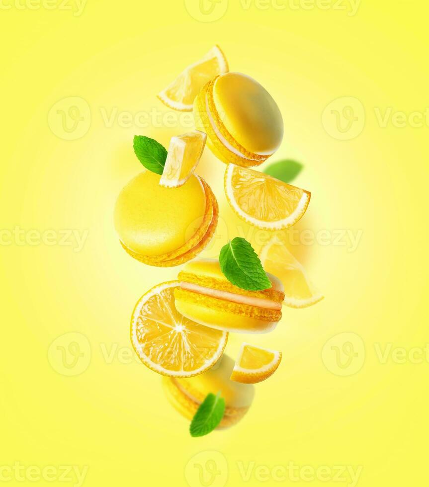 Levitating Yellow French Macarons with mint leaves with lemon photo