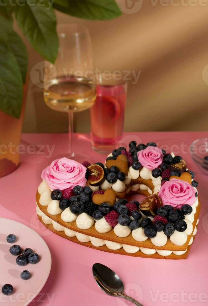 Valentines cake, honey cake, heart cake, birthday pink with wine and roses close up photo