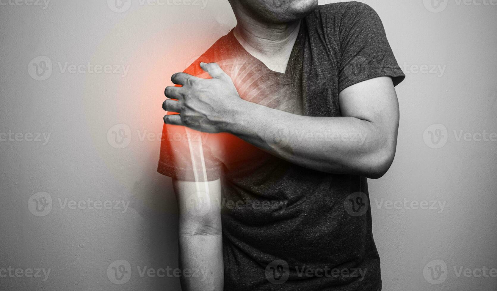 Close up Shoulder pain in a man, Young man holding his shoulder in pain  Shoulder inflammation symptoms medical healthcare concept. photo