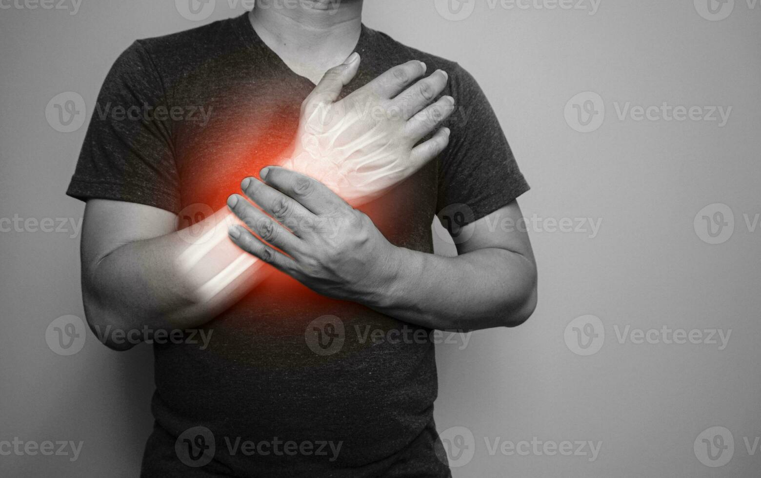 A black and white image of a man with a pain in his right wrist From arthritis symptoms photo