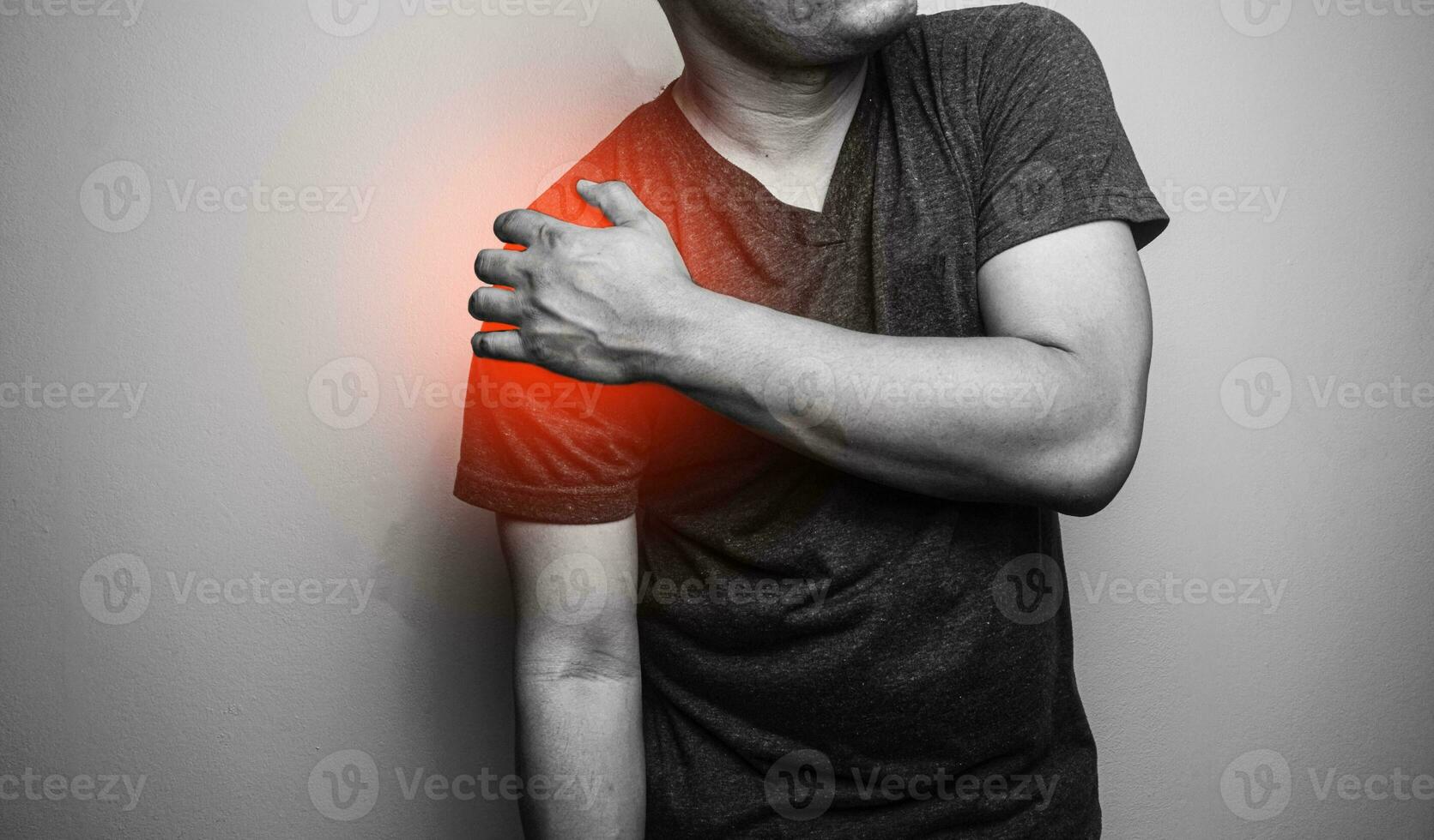 Close up Shoulder pain in a man, Young man holding his shoulder in pain  Shoulder inflammation symptoms medical healthcare concept. photo