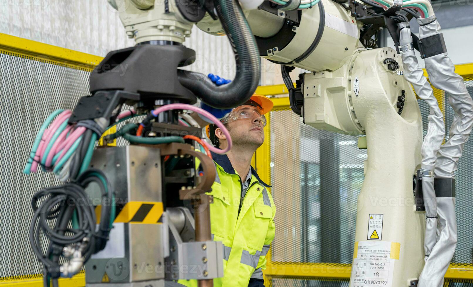 Engineer working and controlling robotics with monitoring system software automation robot arm