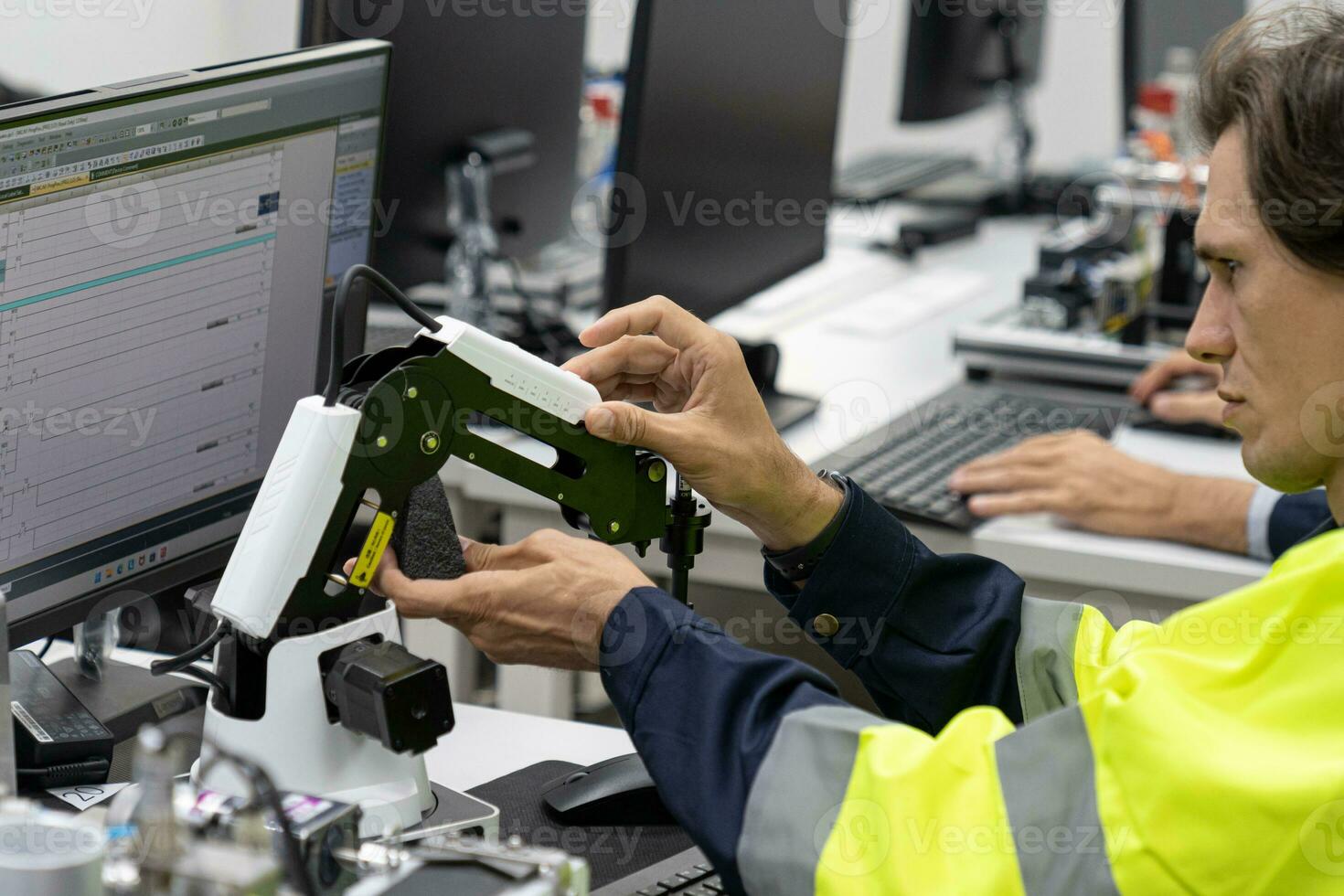 Two male automation machine engineer students studying training Programmable logic controller Technical Industrial Engineer control robotics with monitoring system software, Automation robot arm. photo