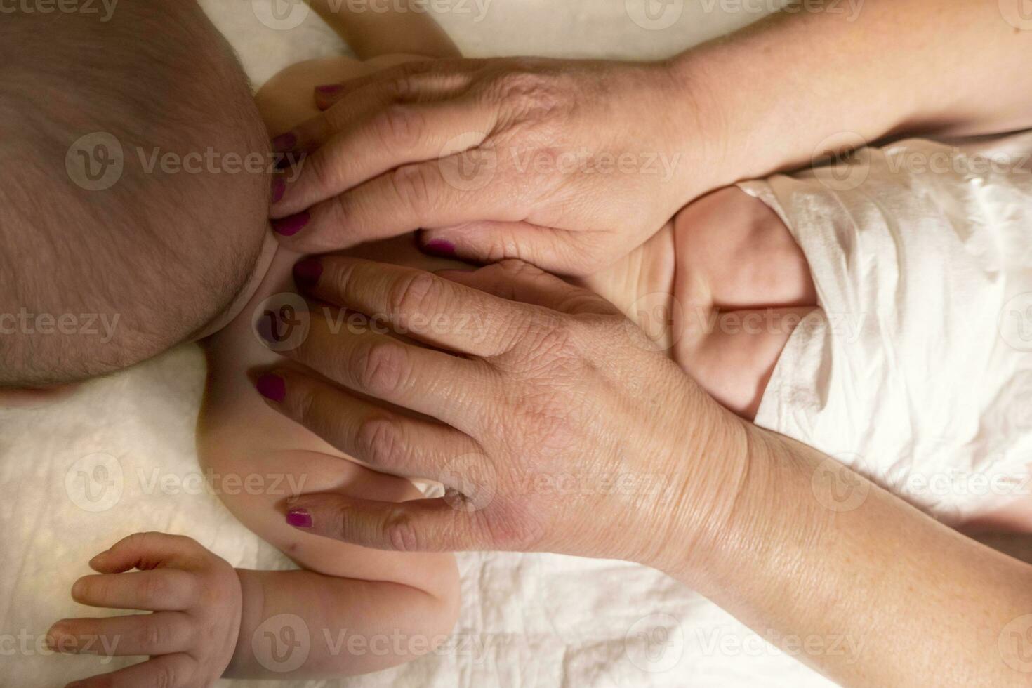 Masseur massaging little baby photo