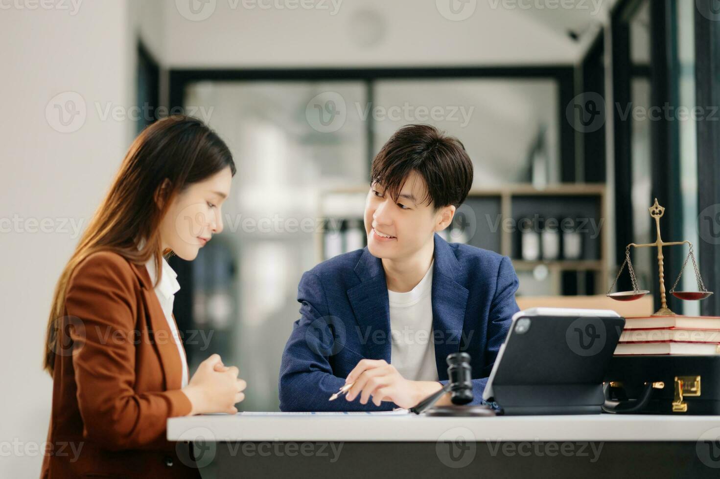 Business people compassionately holding hands and discussing contract papers with laptop and tabletat in office room. photo