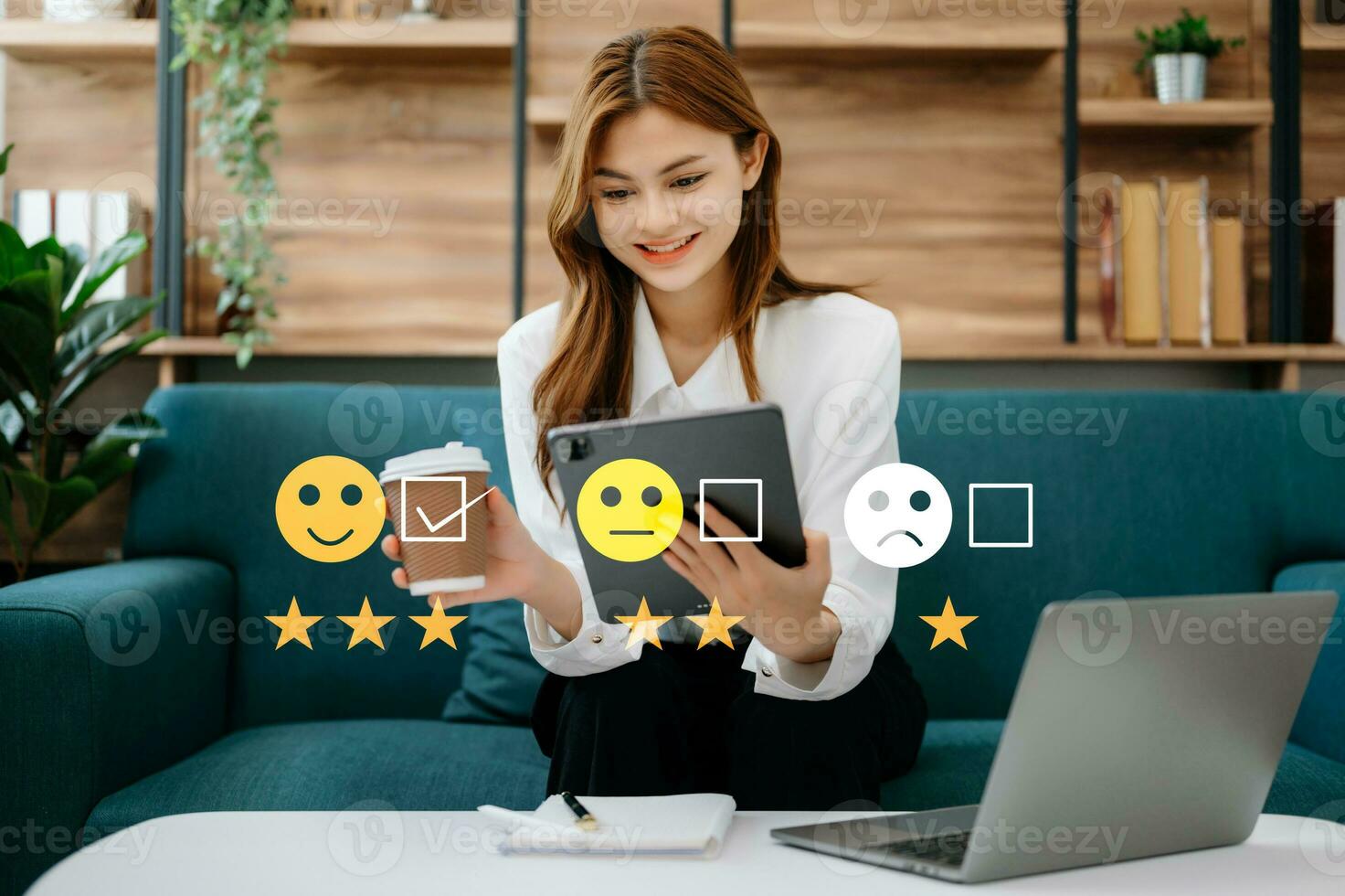 Customer service evaluation concept. Businesswoman pressing face smile emoticon show on virtual screen at tablet and smartphone in office photo