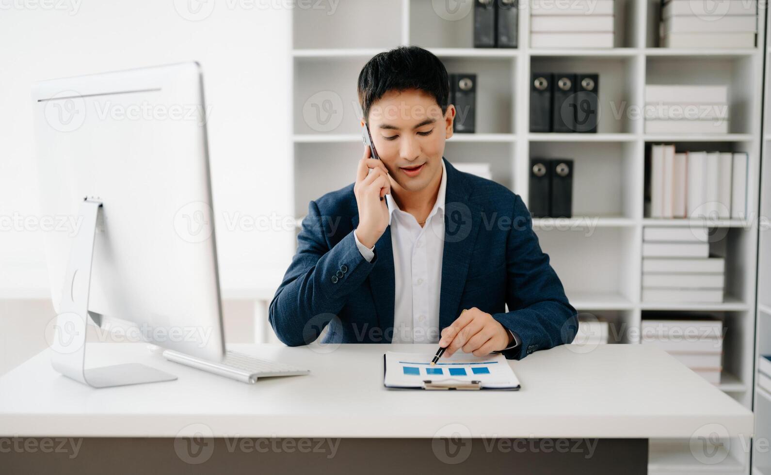 Business man using tablet and laptop for doing math finance on an office desk, tax, report, accounting, statistics, and analytical research concept in office photo