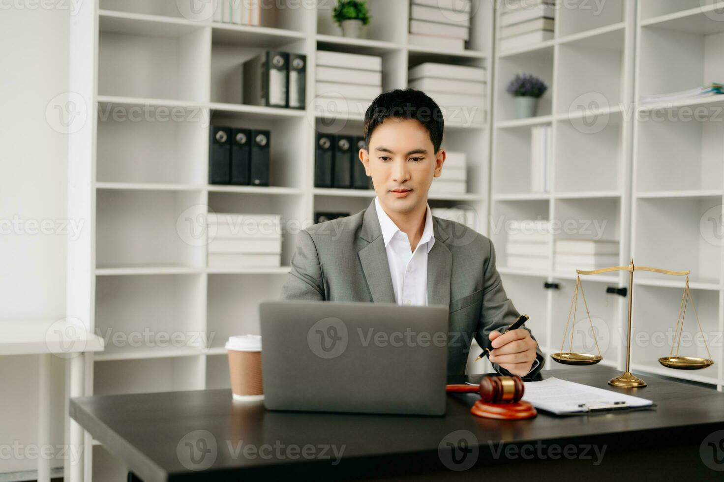 justice and law concept .Asian Male judge in a courtroom on table and Counselor working in office. photo