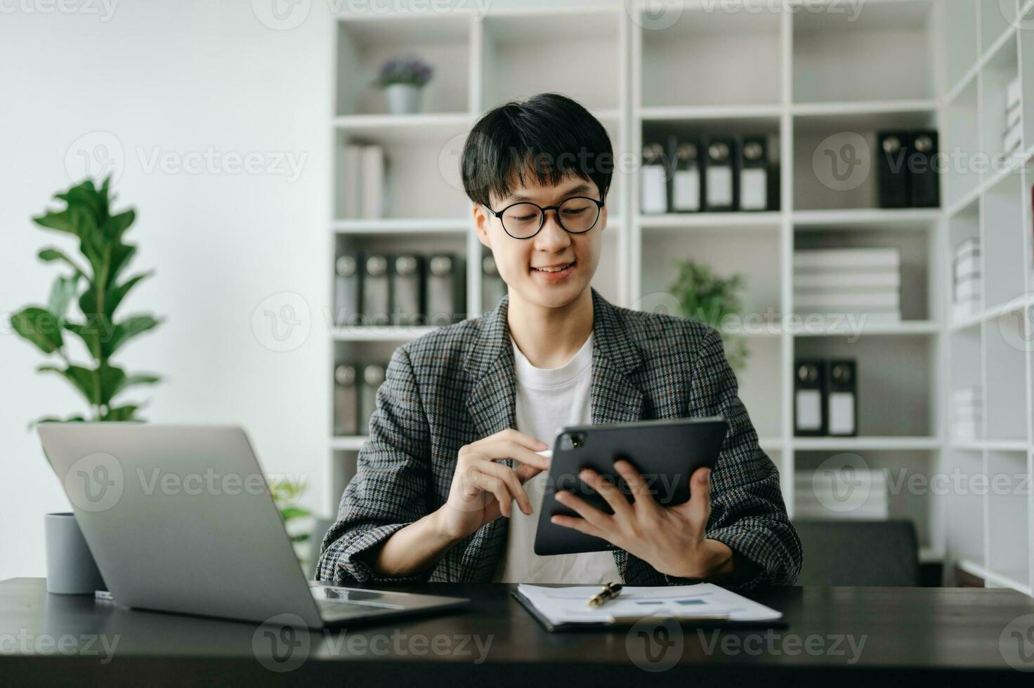 Young business man executive manager looking at laptop watching online webinar training or having virtual meeting video conference doing market research working in office. photo