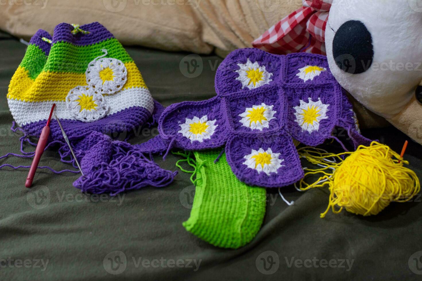 Crochet accessories with koche, using multi-colored threads, handicrafts, on green velvet. photo
