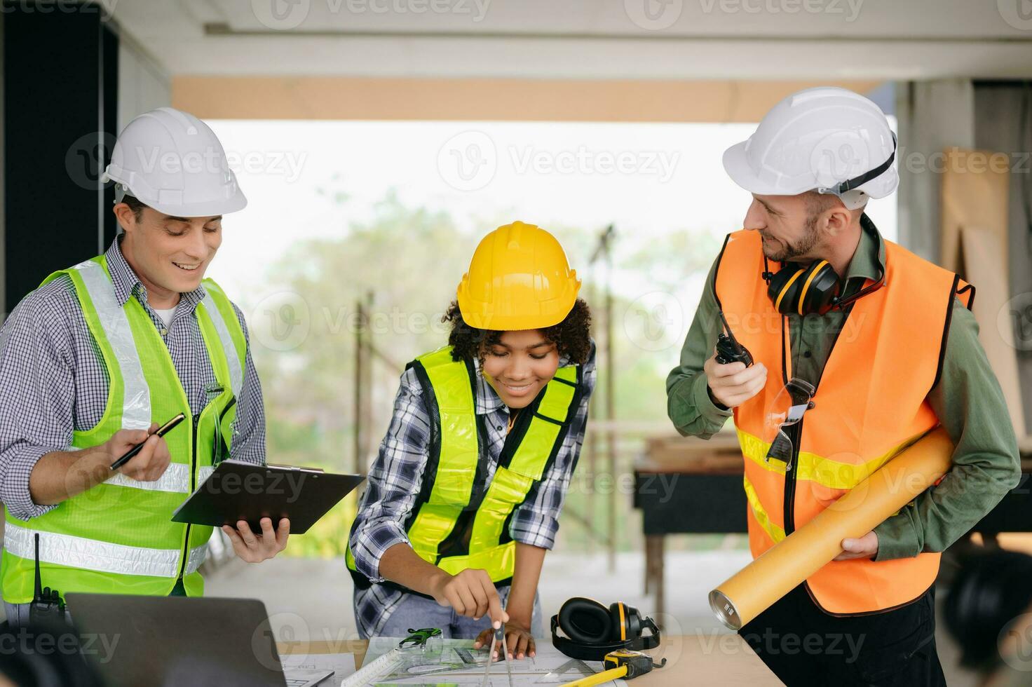 Engineers are discussing data working and laptop or tablet with architectural project at new construction site on big project. photo