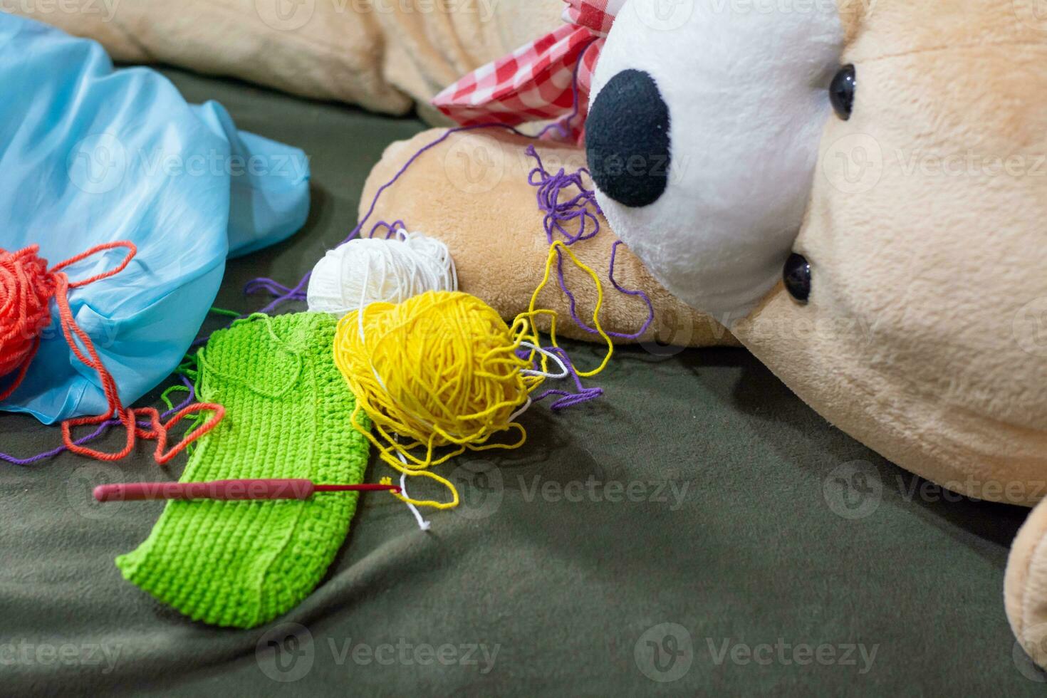 Crochet accessories with koche, using multi-colored threads, handicrafts, on green velvet. photo