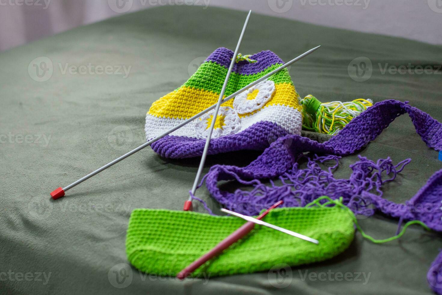 Crochet accessories with koche, using multi-colored threads, handicrafts, on green velvet. photo