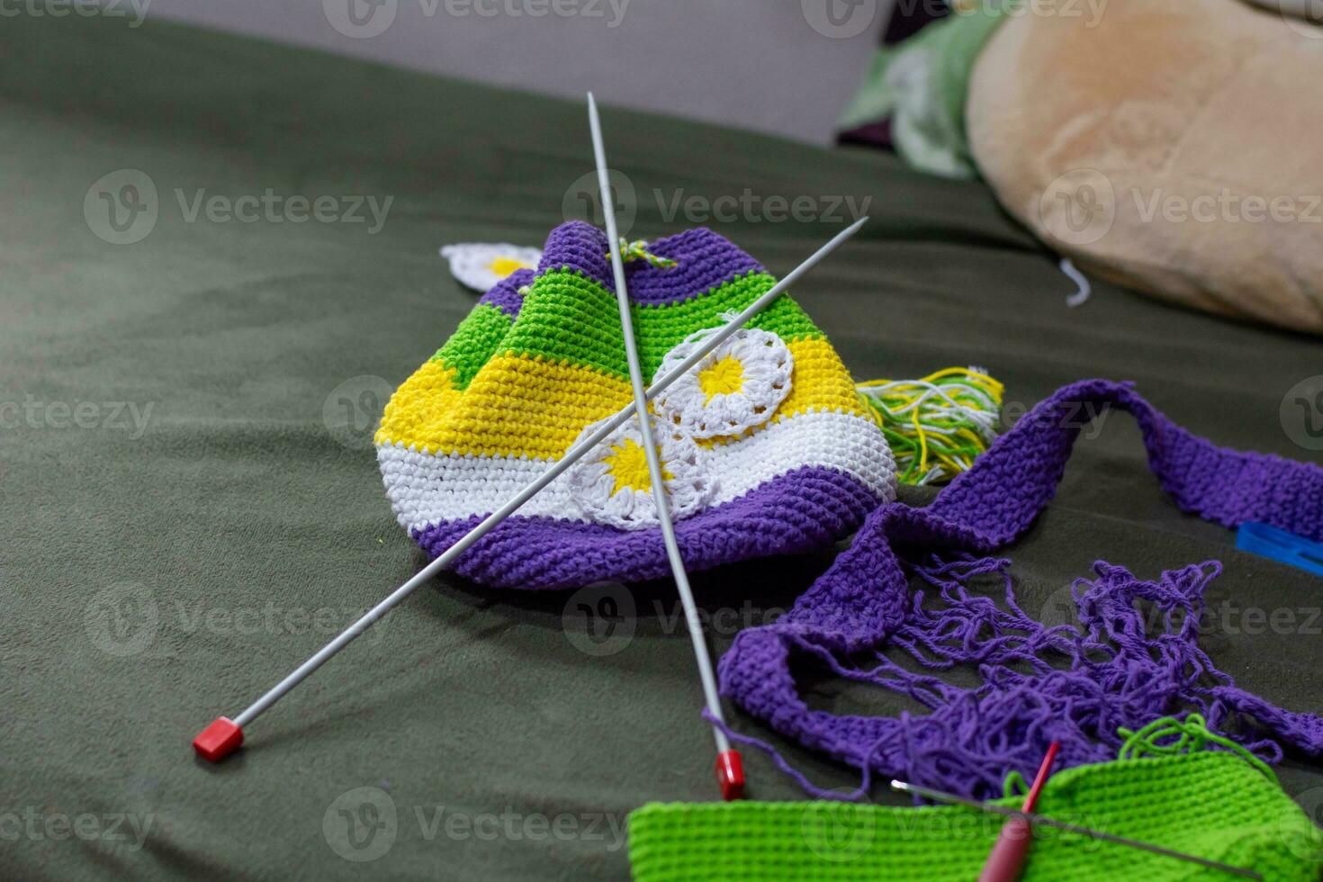 Crochet accessories with koche, using multi-colored threads, handicrafts, on green velvet. photo