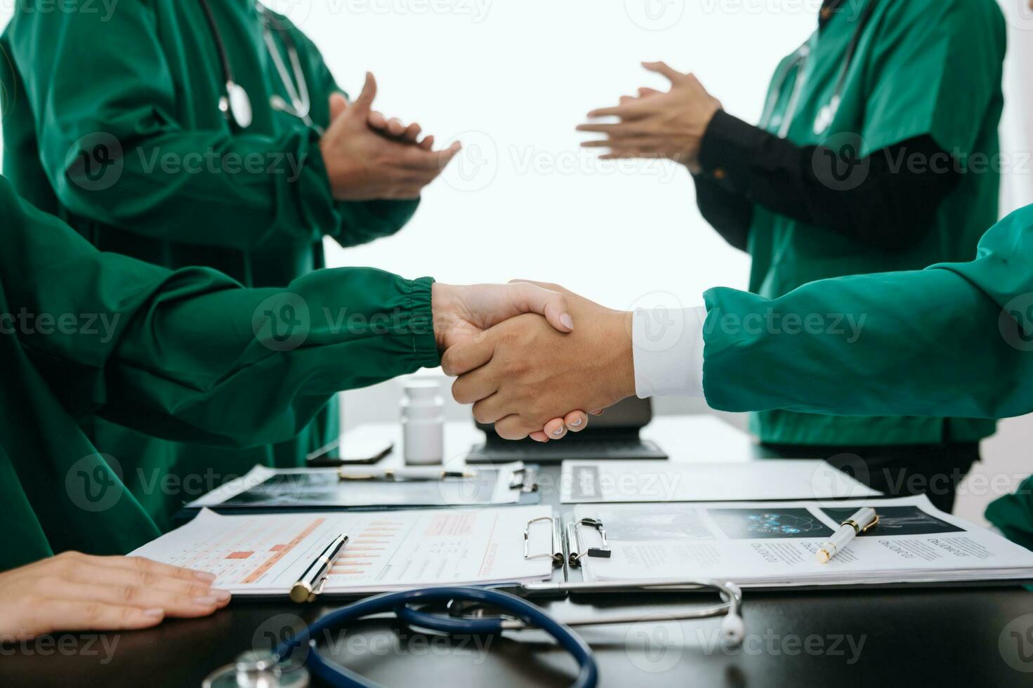 Doctor handshake and partnership in healthcare, medicine or trust for collaboration, unity or support.Team of medical experts shaking hands in teamwork for or success in clinic or hospital photo