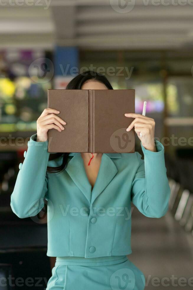 woman was sitting alone reviewing her lesson to understand and learn lesson before attending training and testing her knowledge of assigned book articles. Concepts of reading to learn and comprehend. photo