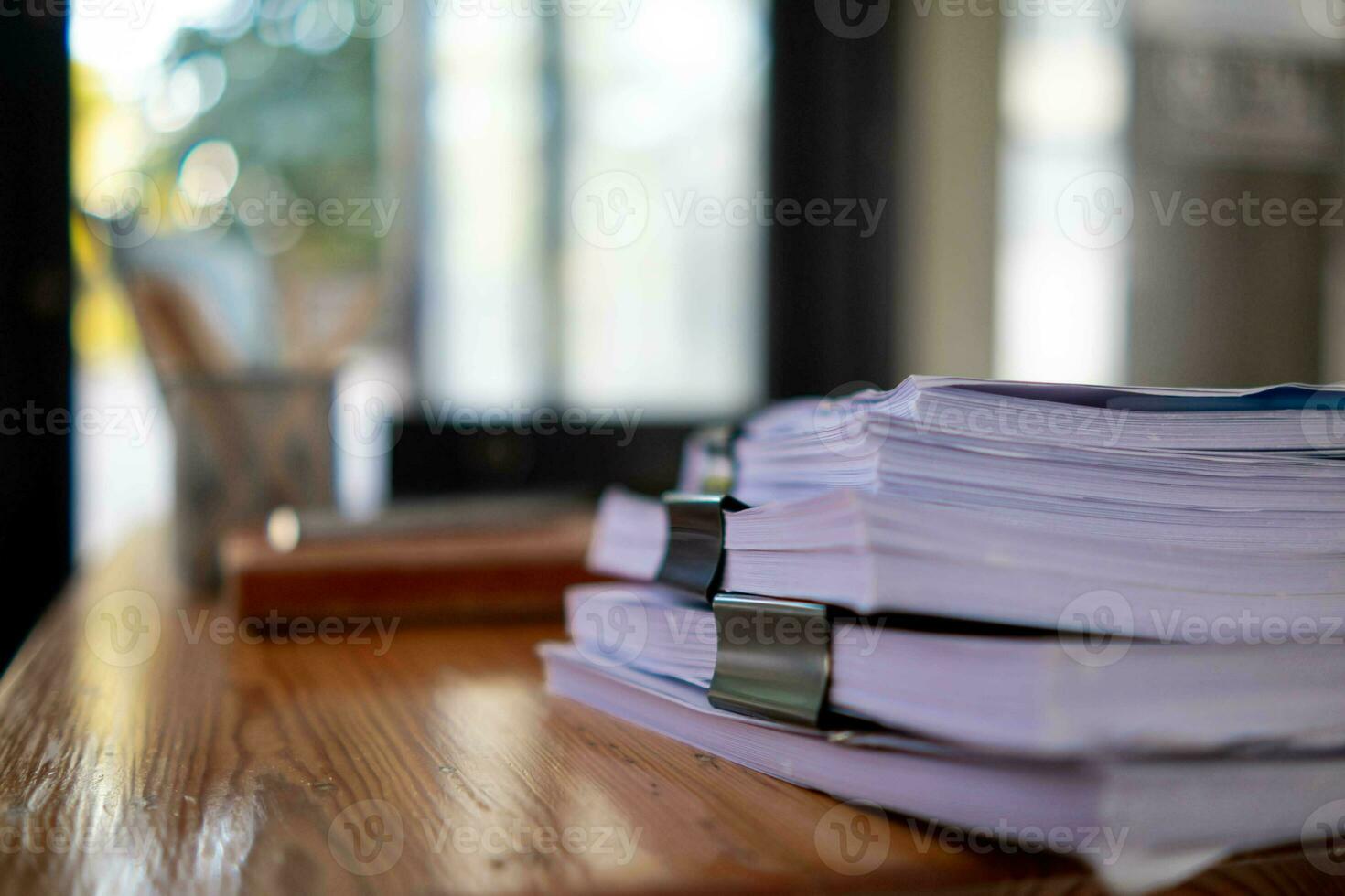 A huge stacked documents is an annual earnings summary document prepared for business people to use in attending meetings and this stacked paper is also an important document. photo