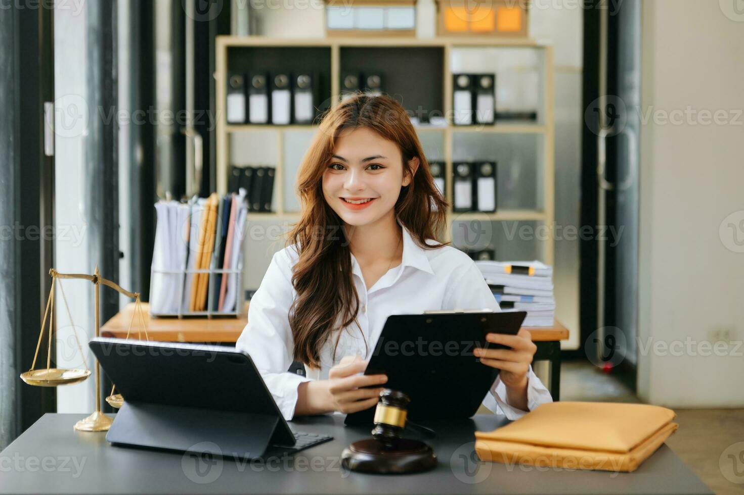 Beautiful asian woman lawyer working and gavel, tablet, laptop in front, Advice justice and law concept. photo