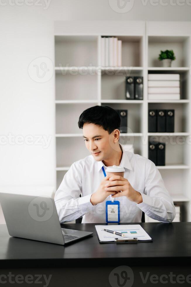 Businessman using tablet and laptop for doing math finance on an office desk, tax, report, accounting, statistics, and analytical research concept in office photo