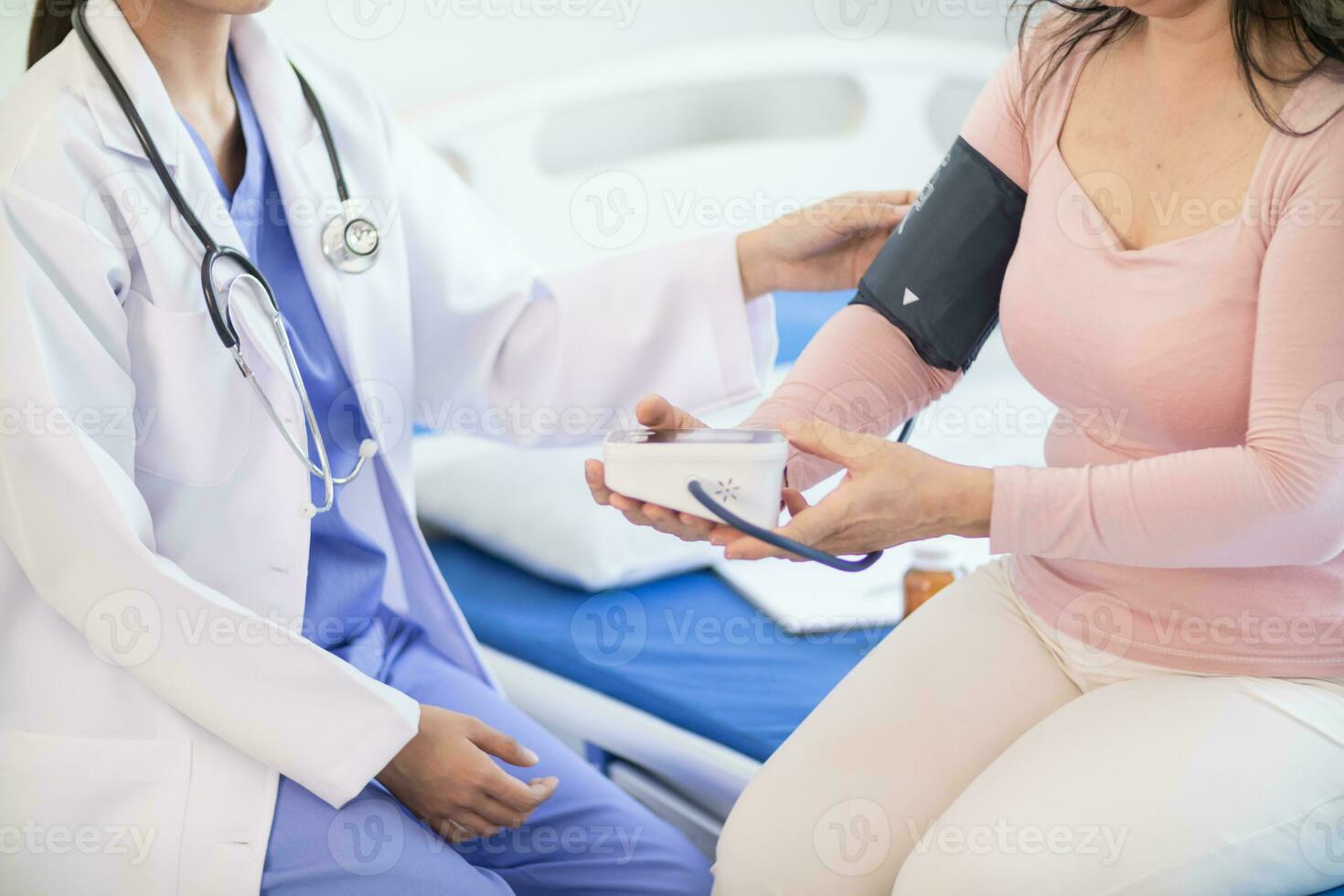 The doctor is using a blood pressure monitor on an elderly patient to check whether the blood pressure is abnormally high or not because hypertension often happens to the elderly and is dangerous. photo