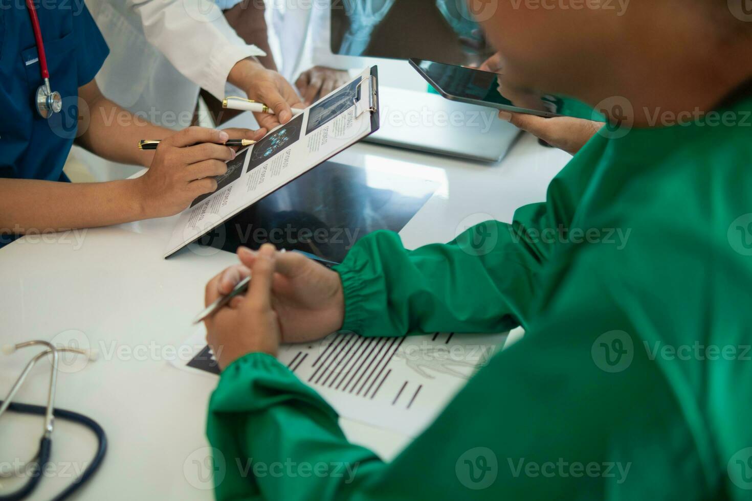 concept of mobilizing ability of medical team in conference room to diagnose and treat disease correctly. medical team joins meeting and discusses  patient illness in order to treat it correctly photo