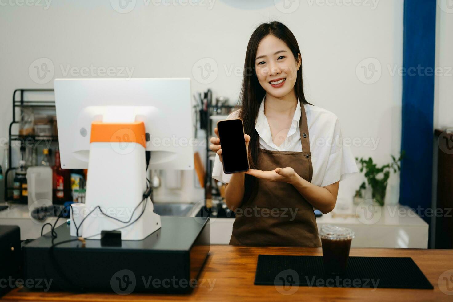 Asian female coffee shop owner in a coffee shop photo
