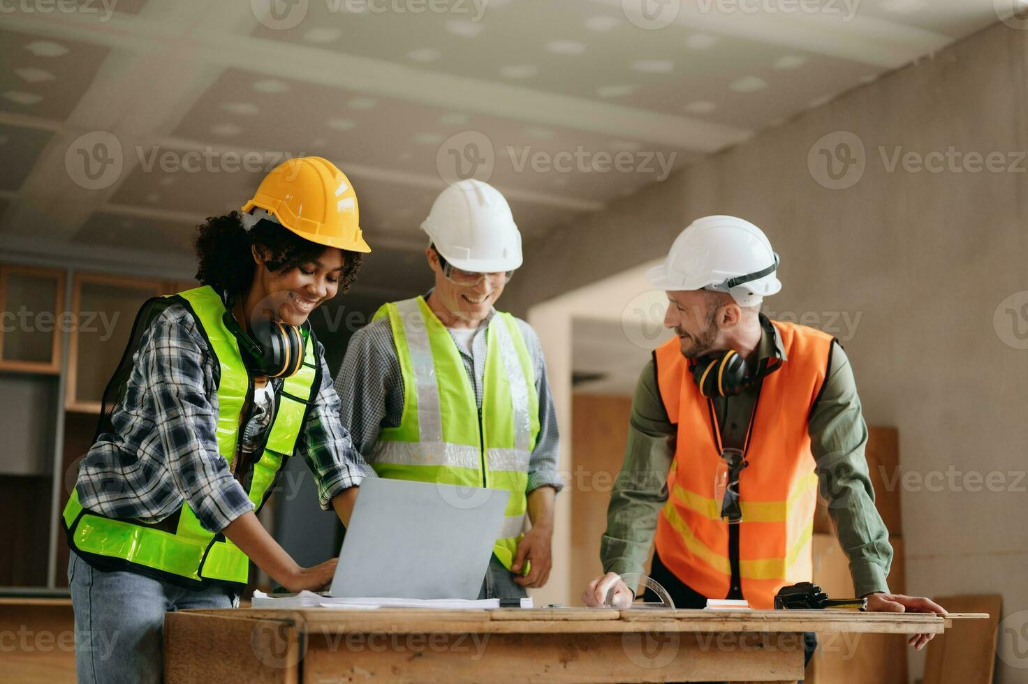 Architect caucasian man and woman working with colleagues mixed race in the construction site. Architecture engineering on big project. Building in construction process interior. photo