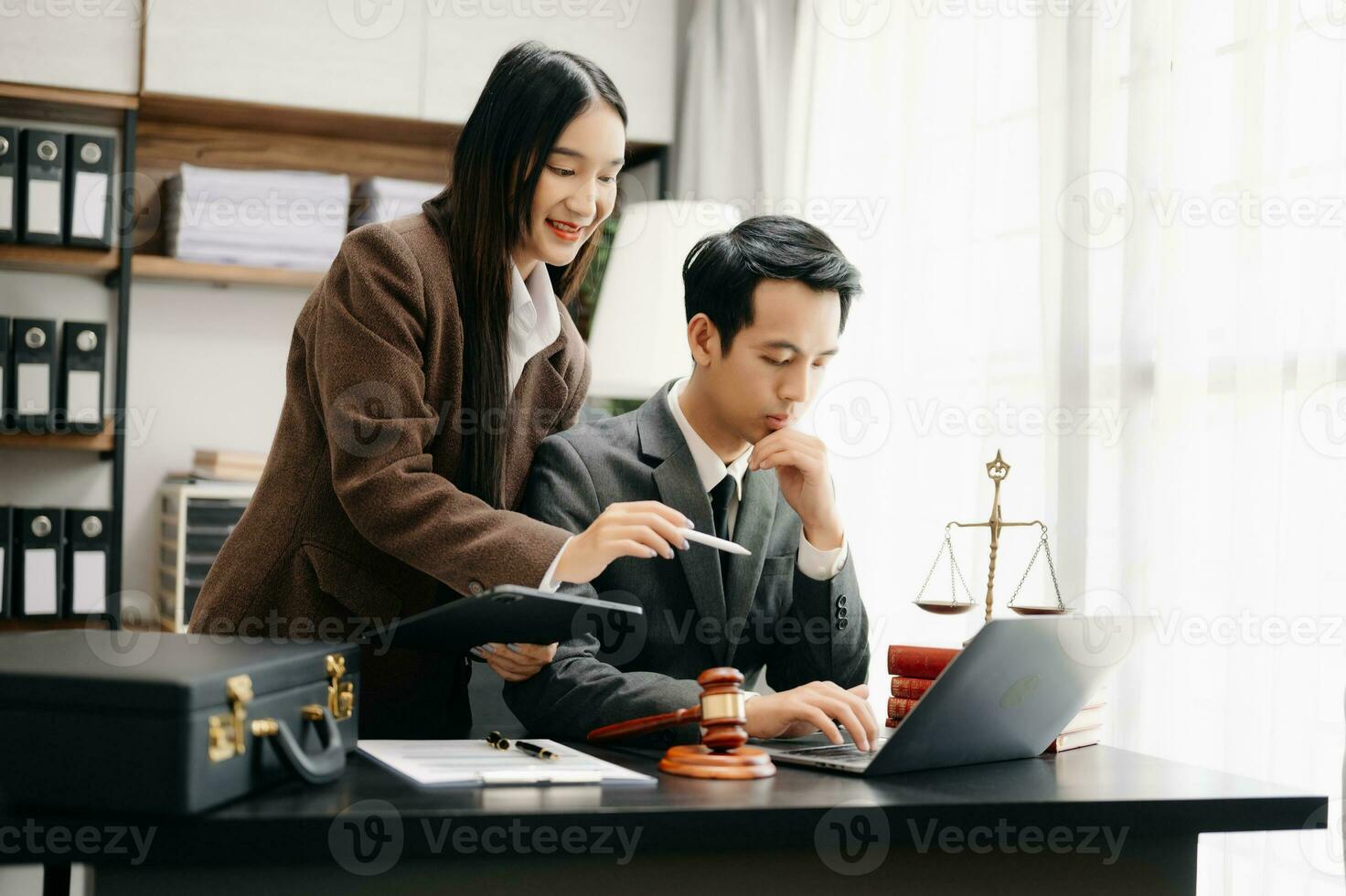 Asian business team and lawyers discussing contract papers sitting at the table. Concepts of law, advice, legal services. at modern office photo