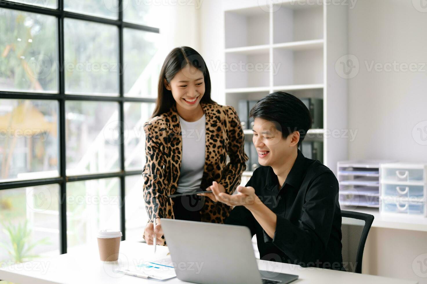 Two Asian business woman and man  discuss investment project working and planning strategy with tablet laptop computer in office. photo