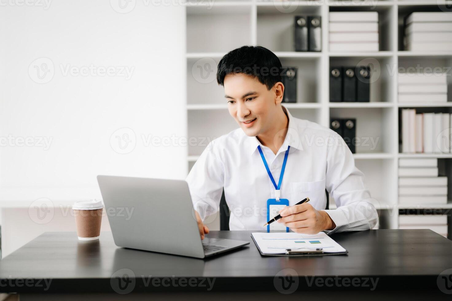 Businessman using tablet and laptop for doing math finance on an office desk, tax, report, accounting, statistics, and analytical research concept in office photo