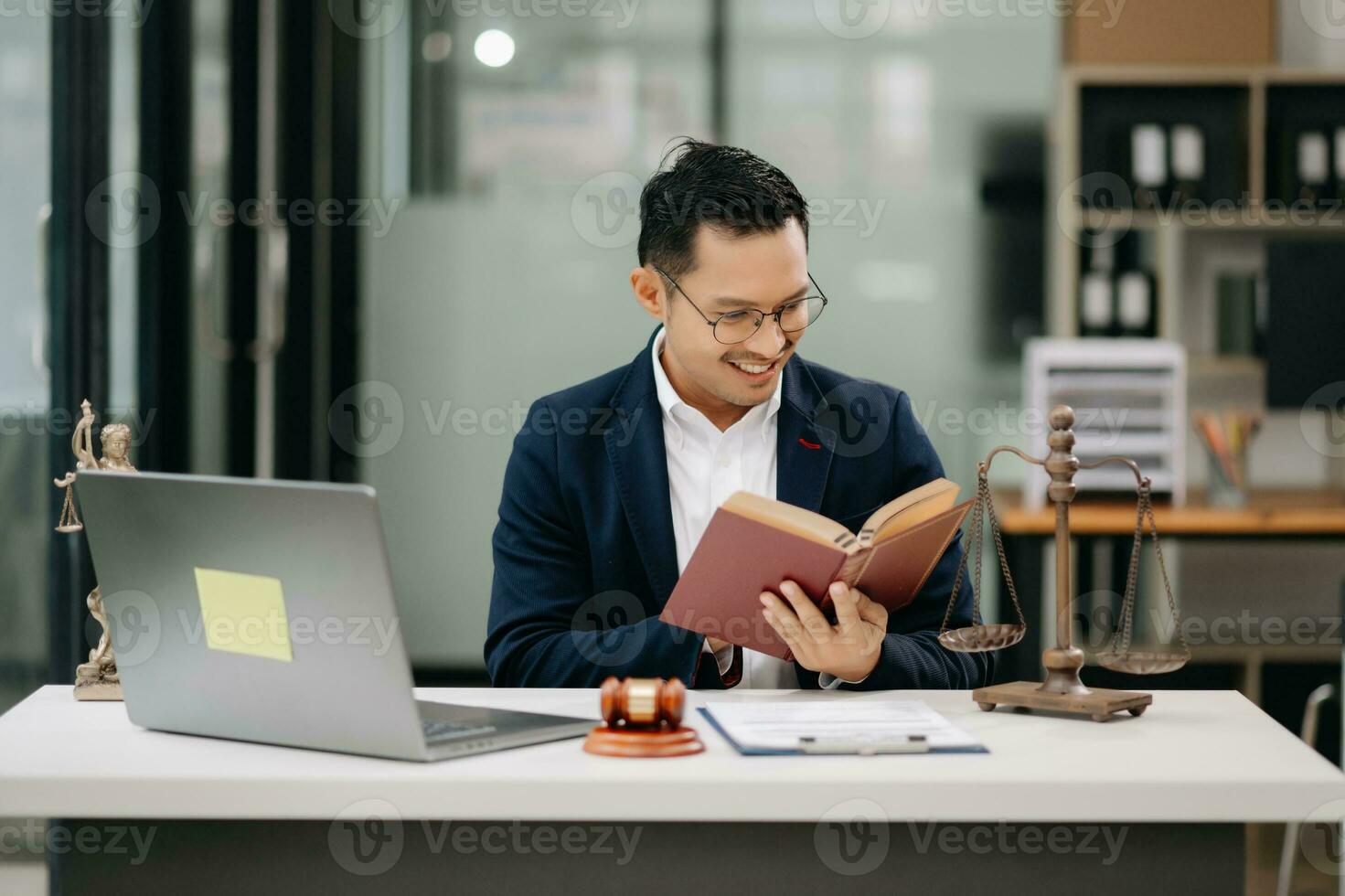 Man lawyer reading legal book with gavel on table in office. justice and law ,attorney concept. photo