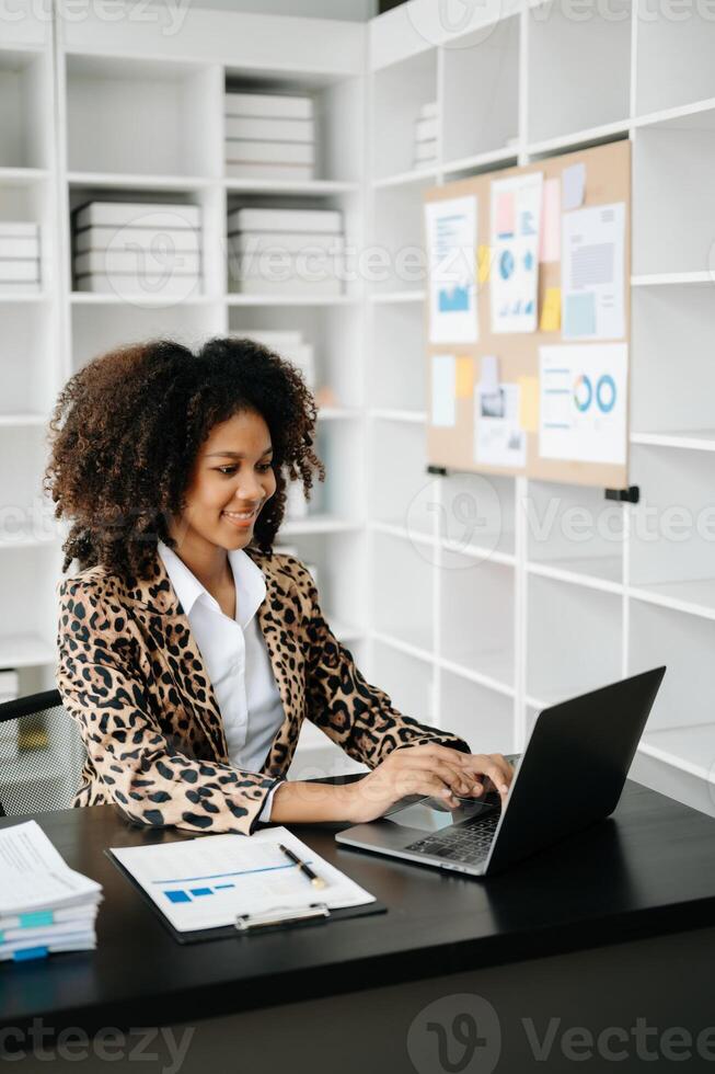 Business woman using tablet and laptop for doing math finance on an office desk, tax, report, accounting, statistics, and analytical research concept in office photo