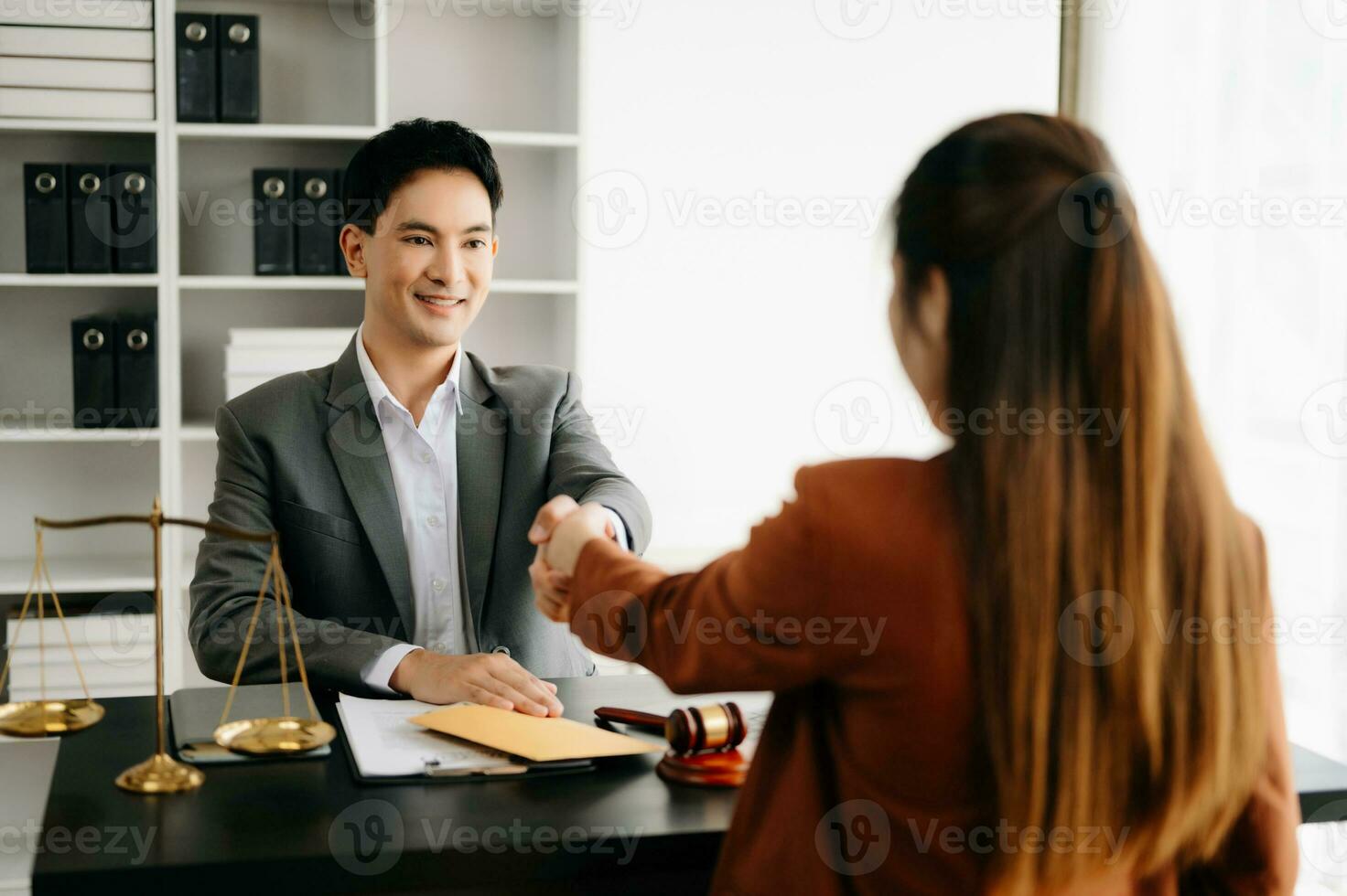 justice and law concept.passing bribe money in the envelop at lawyer office. businessman hand taking bribe money from female photo