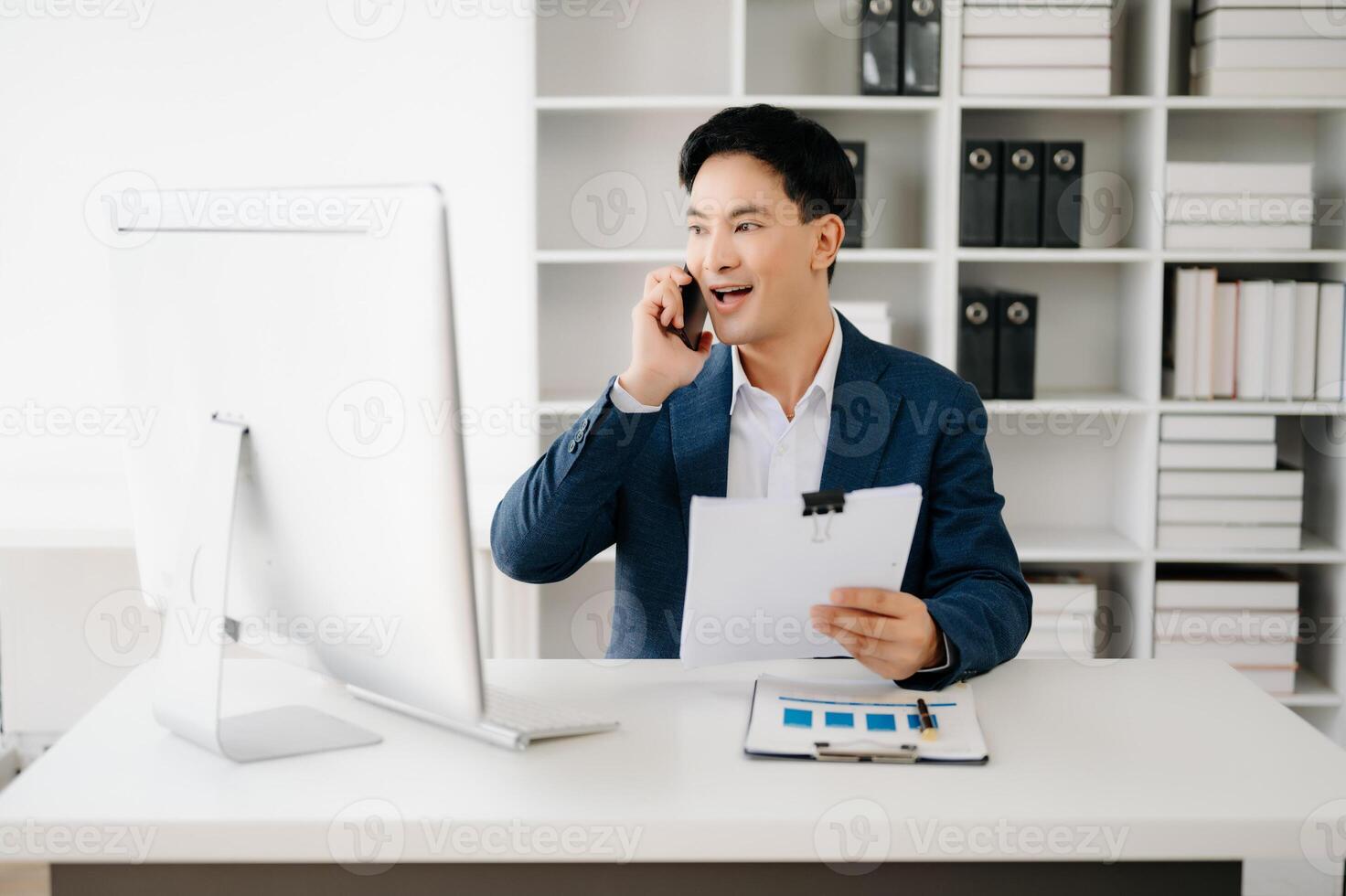 Business man using tablet and laptop for doing math finance on an office desk, tax, report, accounting, statistics, and analytical research concept in office photo