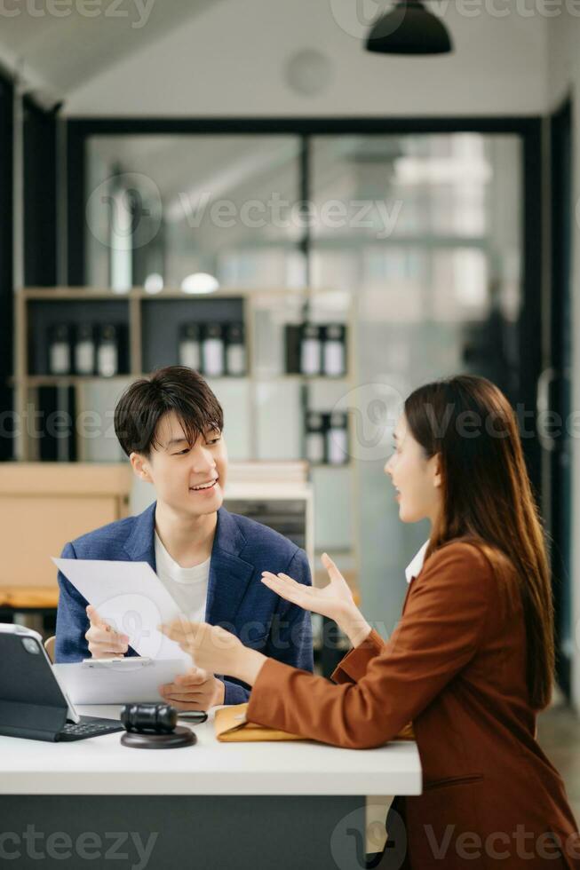 Asian business team and lawyers discussing contract papers sitting at the table. Concepts of law, advice, legal services. at office photo