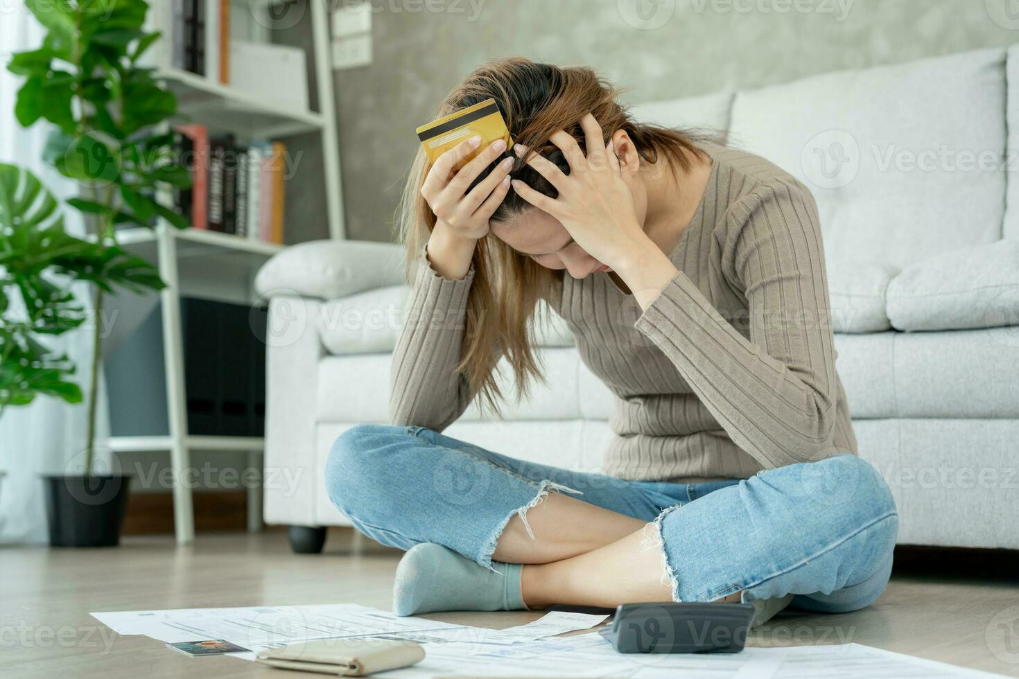 Stressed and headache asian woman with large bills or invoices no money to pay to expenses and credit card debt. shortage, Financial problems, mortgage, loan, bankruptcy, bankrupt, poor, empty wallet photo