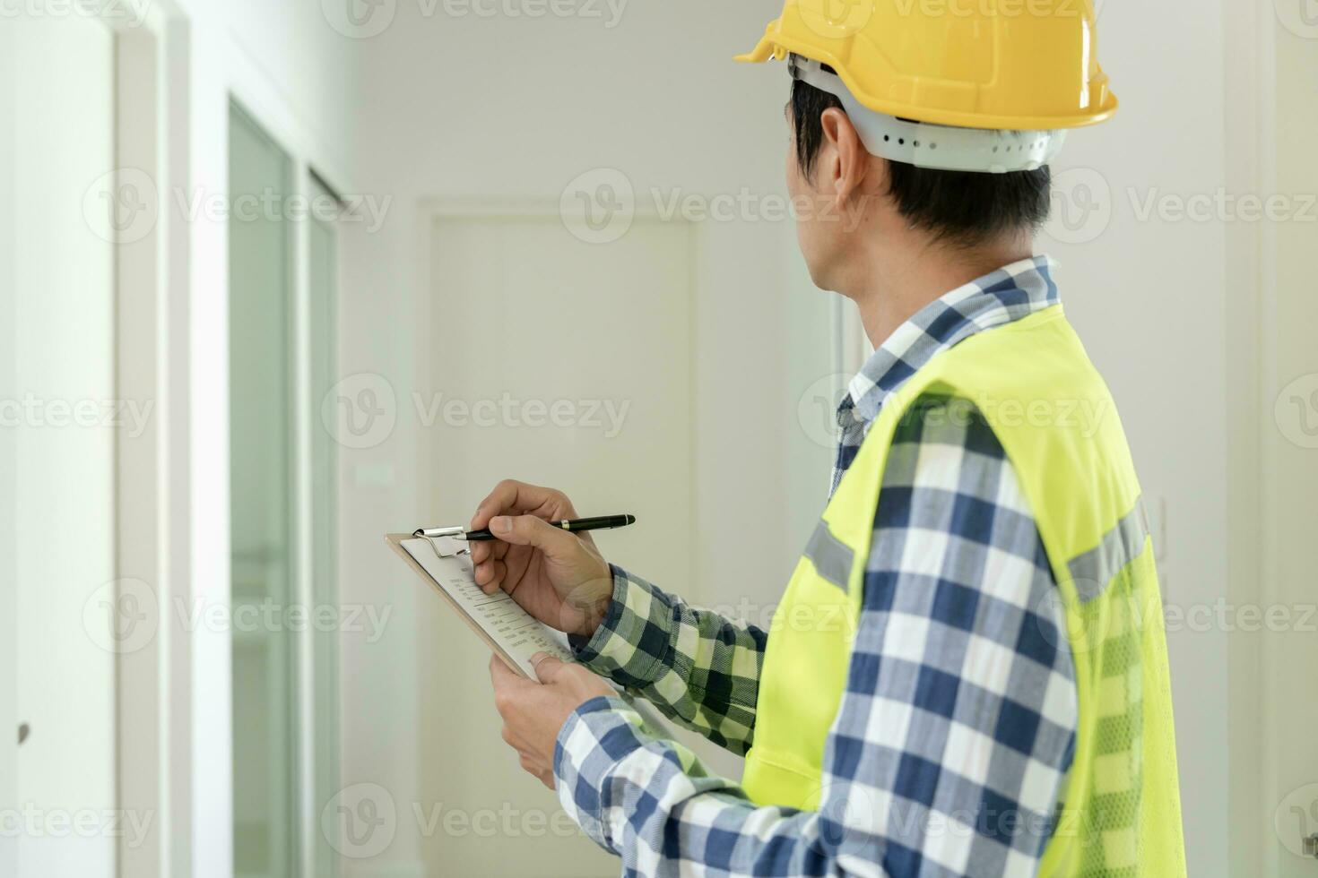 inspector or engineer is inspecting construction and quality assurance new house using a checklist. Engineers or architects or contactor work to build the house before handing it over to the homeowner photo