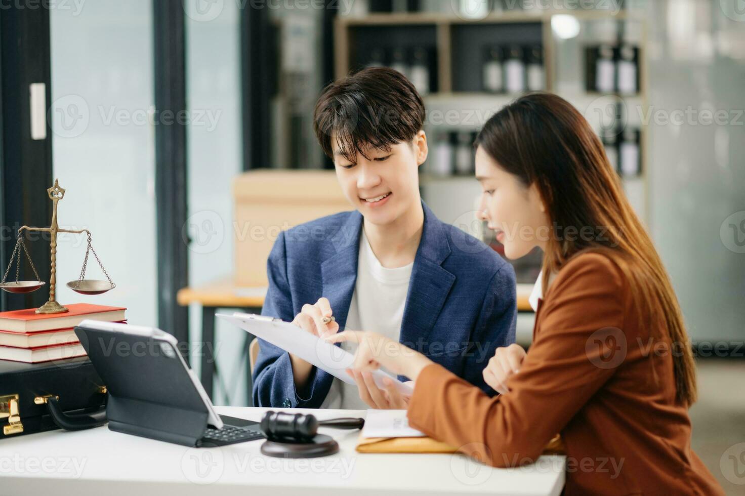 Business people compassionately holding hands and discussing contract papers with laptop and tabletat in office room. photo