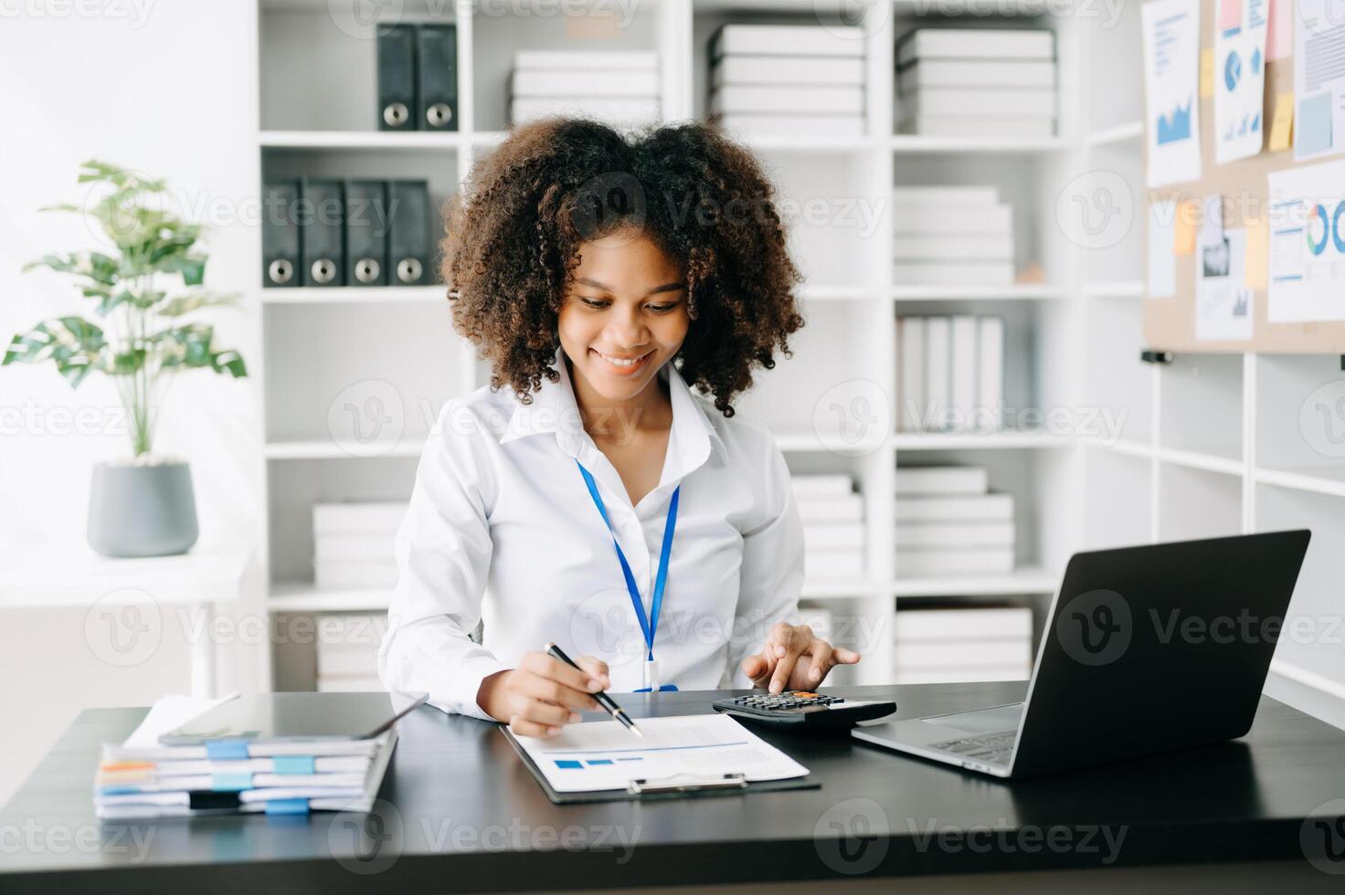 Business woman using tablet and laptop for doing math finance on an office desk, tax, report, accounting, statistics, and analytical research concept in office photo