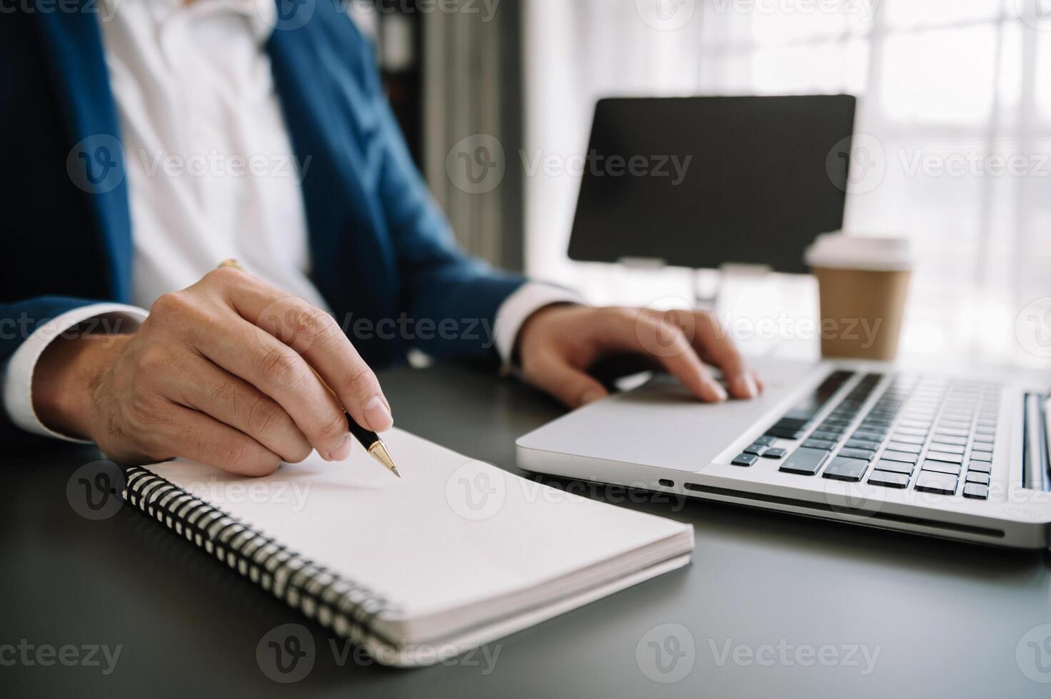 businesswoman hand working with new modern computer and writing on the notepad strategy diagram as concept morning light photo