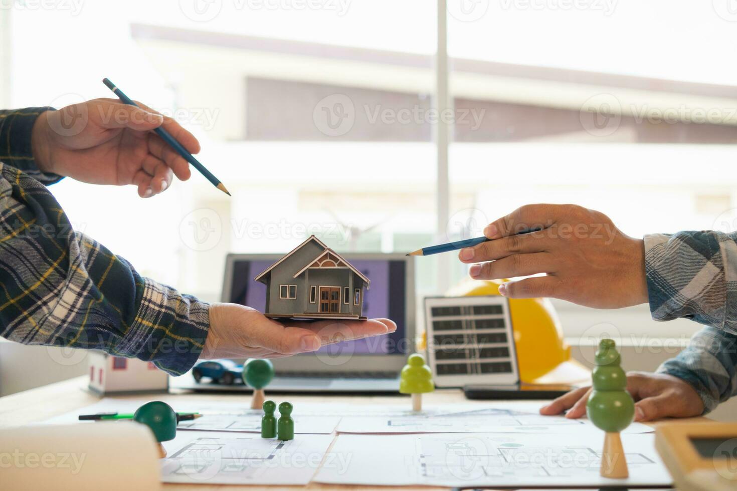 Architects and engineers discuss how to design  housing estate to ensure construction is up to standard and completed on time. team of engineers and architects discuss building design and structure. photo