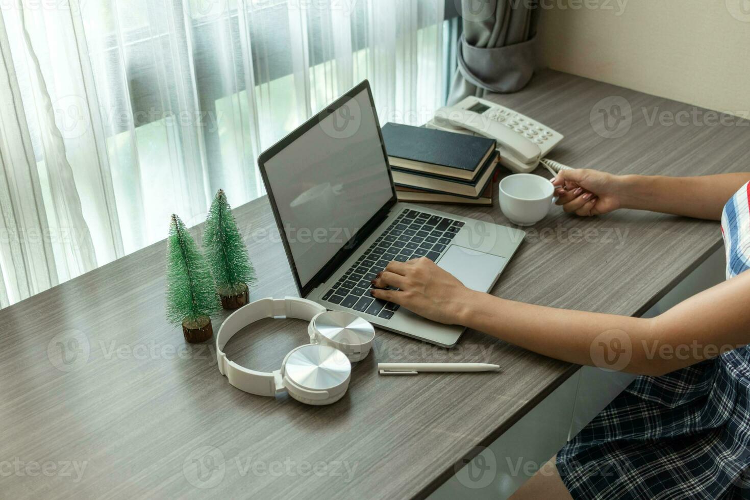 Young women work from home and use laptop computers to search for information and communicate with colleagues to work online. The concept of working from home with Notebook via online system. photo