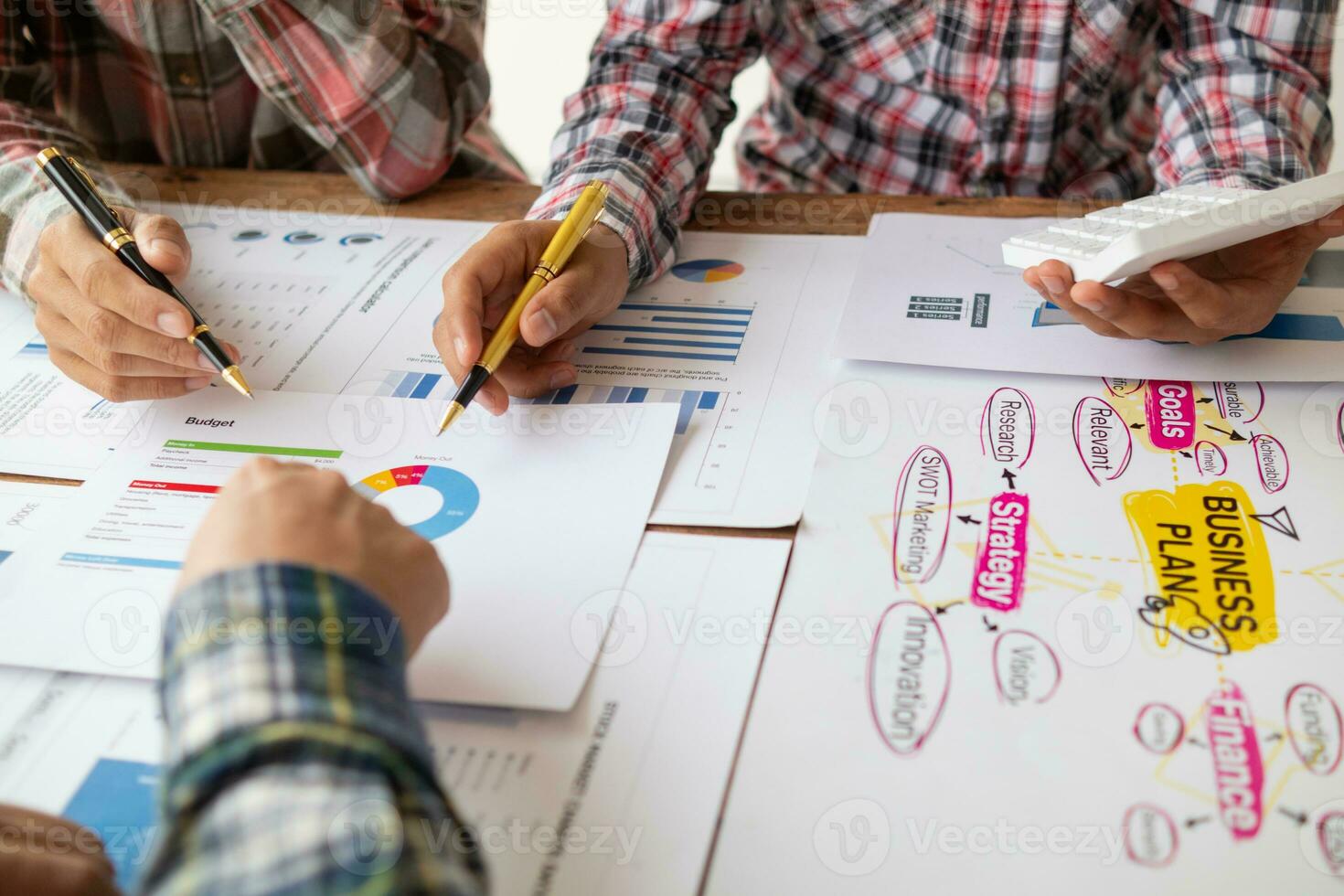 Businessmen and investors form a group of startups and business plans together in a meeting room. A group of startup entrepreneurs are discussing investment plans and profits. photo