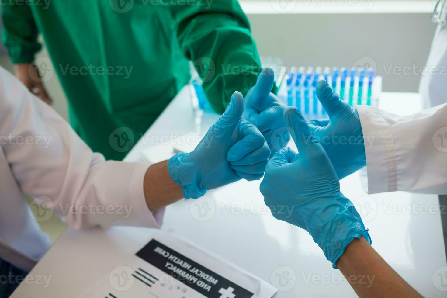 The medical team joins hands after the meeting and discusses the treatment of severely ill patients and can come to a conclusion on the surgical treatment of the patient. Medical team meeting concept photo