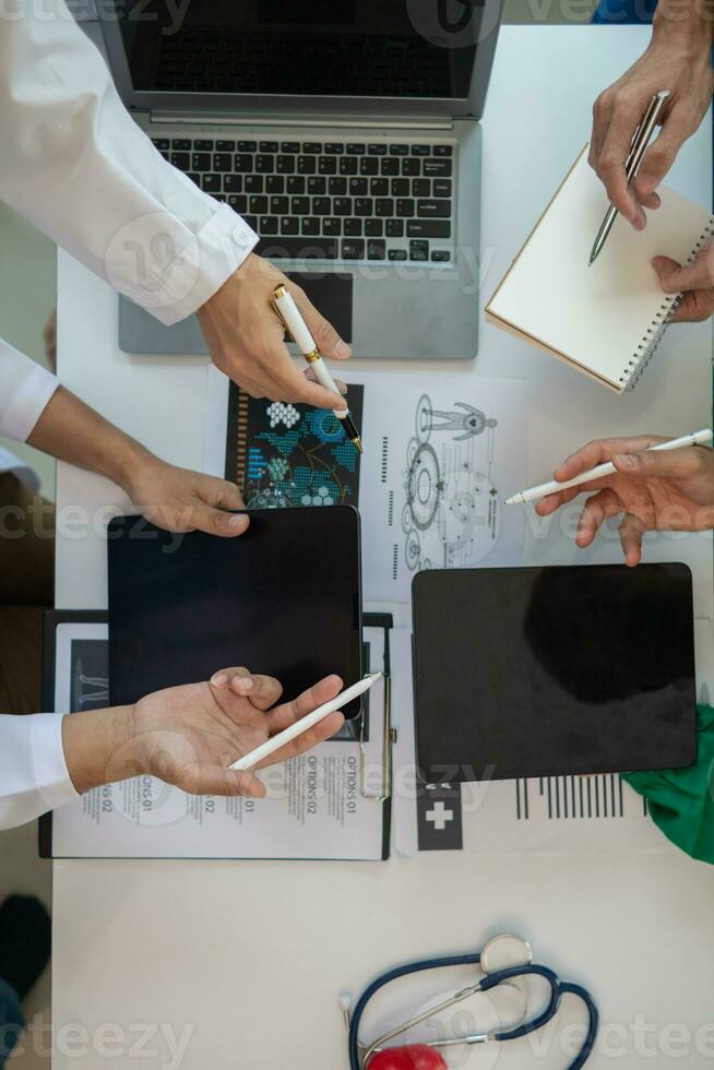 Medical team meeting with surgical surgeon in white coats and surgical team discussing patient condition documenting successful medical health treatment. concept of working with medical team photo