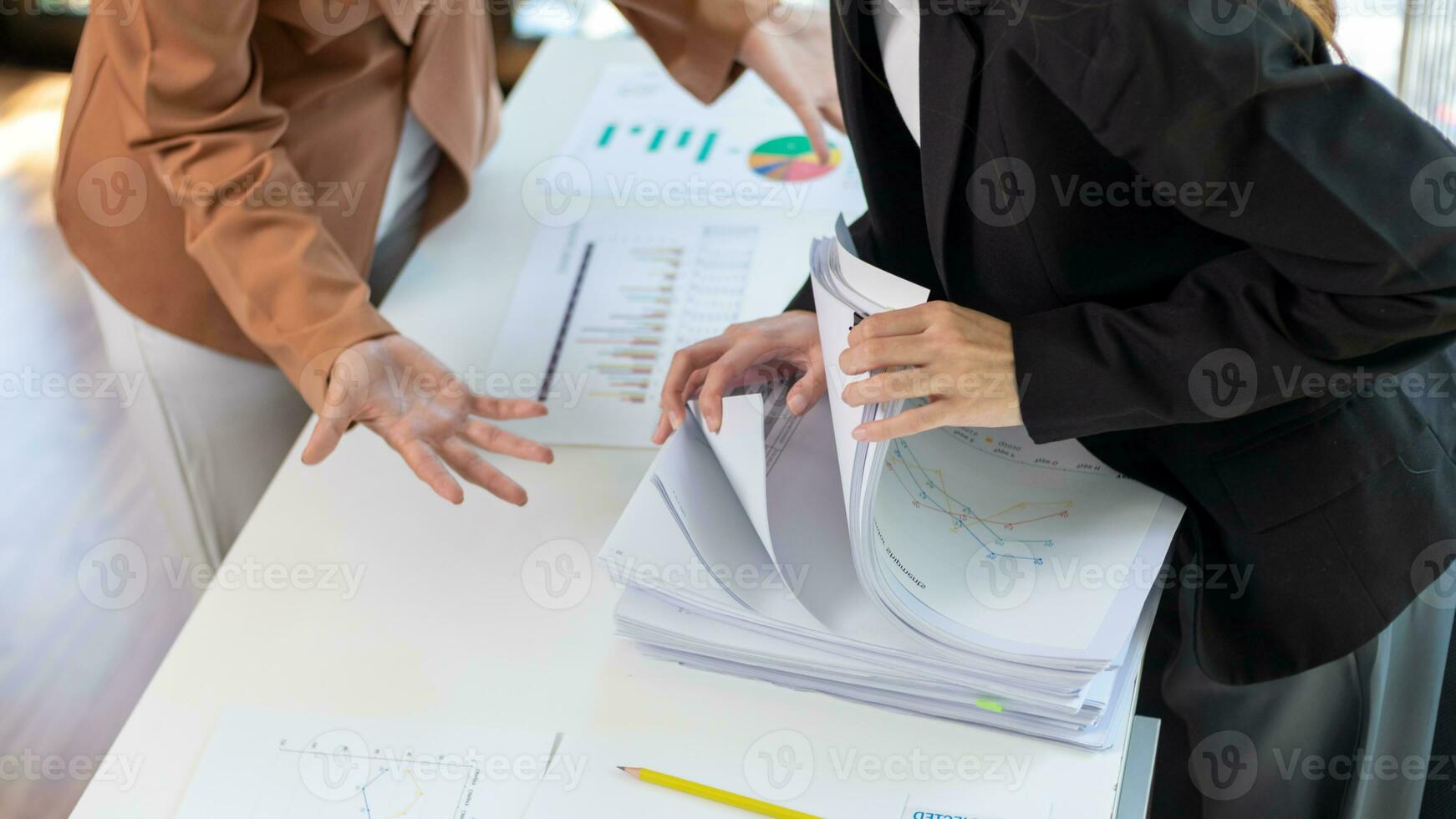secretary searches through stacked documents on desk in office to find lease within stacked documents just before meeting. concept difficulty in finding hire purchase contract from stacked documents photo