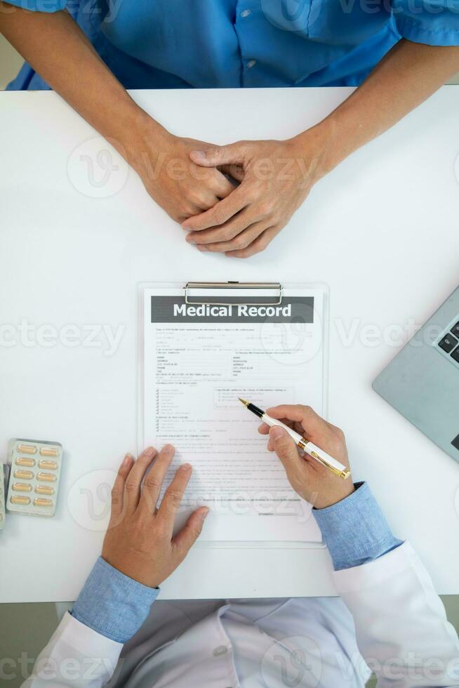 A heart patient visits a doctor for advice on health care and medication to treat heart disease symptoms after the medical team has diagnosed and examined the patient for heart abnormalities. photo