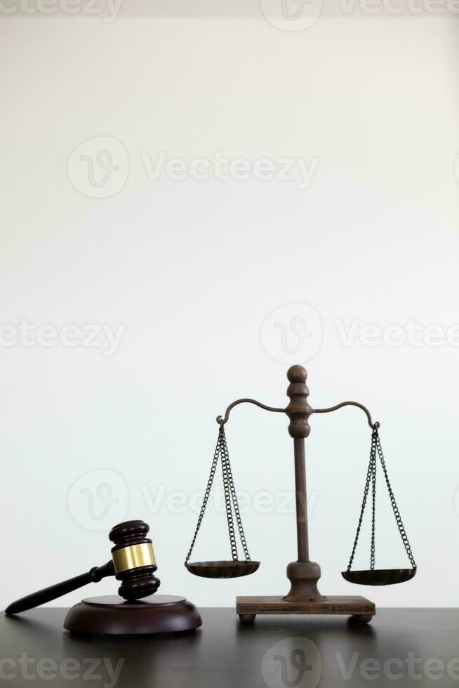 gavel wood and Brass court scales are used to decorate a table in a legal advisor office for aesthetic reasons ,Because the brass court scales are a symbol of justice. legal advisor concept. photo